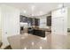 A spacious kitchen featuring stainless appliances, dark cabinets, stone countertops and hardwood floors at 1089 Seburn Rd, Apopka, FL 32703