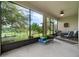 Spacious screened lanai with seating, play equipment, and views of the backyard at 1089 Seburn Rd, Apopka, FL 32703