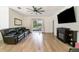Spacious living room with hardwood floors, a ceiling fan, and a sliding glass door to the backyard at 1089 Seburn Rd, Apopka, FL 32703