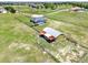 Aerial view of estate with home, barn, pool and fenced-in yard with mature trees and landscaping at 11115 Romance Ct, Winter Garden, FL 34787