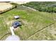 Expansive fenced property features a house, outbuilding, pool, and circular driveway surrounded by lush green pastures at 11115 Romance Ct, Winter Garden, FL 34787