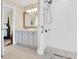 Modern bathroom with a double vanity, shower and neutral tile flooring at 11115 Romance Ct, Winter Garden, FL 34787