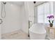 Bathroom features a walk-in shower, soaking tub, and white subway tile at 11115 Romance Ct, Winter Garden, FL 34787