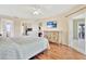 Bedroom boasts wood floors, TV, dresser and access to balcony with sliding glass door at 11115 Romance Ct, Winter Garden, FL 34787