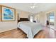 Bedroom features wood floors, ceiling fan, and ensuite bathroom access at 11115 Romance Ct, Winter Garden, FL 34787