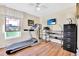This bedroom features a treadmill and a desk, creating a versatile space for work and exercise at 11115 Romance Ct, Winter Garden, FL 34787