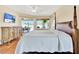 A bright bedroom with a four-poster bed, ceiling fan, and sliding door to the patio at 11115 Romance Ct, Winter Garden, FL 34787