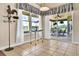 Bright breakfast nook with tile floors, and a view of the screened patio, complemented by a charming rooster weathervane at 11115 Romance Ct, Winter Garden, FL 34787
