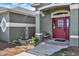 Inviting front entry with a red door, charming fountain, and bench seating at 11115 Romance Ct, Winter Garden, FL 34787