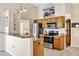 A kitchen showcasing granite countertops, stainless steel appliances and light wood cabinets at 11115 Romance Ct, Winter Garden, FL 34787