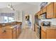 Kitchen with granite countertops, wood cabinets, stainless steel dishwasher and appliances at 11115 Romance Ct, Winter Garden, FL 34787