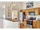 A kitchen showcasing granite countertops, stainless steel appliances and light wood cabinets at 11115 Romance Ct, Winter Garden, FL 34787