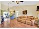 Bright living room with hardwood floors, a ceiling fan, and sliding door access to the patio at 11115 Romance Ct, Winter Garden, FL 34787