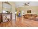 Spacious living room boasts hardwood floors, a decorative fireplace, and comfortable seating at 11115 Romance Ct, Winter Garden, FL 34787