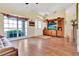 Bright living room with hardwood floors, large window and a wooden entertainment center at 11115 Romance Ct, Winter Garden, FL 34787