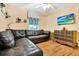 Well-lit living room features a plush sectional sofa, hardwood floors, and a mounted TV at 11115 Romance Ct, Winter Garden, FL 34787