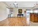 Open-concept room featuring hardwood floors, a built-in cabinet, a desk, and granite counters at 11115 Romance Ct, Winter Garden, FL 34787