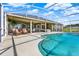 Backyard oasis with a screened-in pool, outdoor seating, and a covered patio, ideal for entertaining at 11115 Romance Ct, Winter Garden, FL 34787