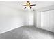 Neutral bedroom with gray carpet, ceiling fan, and closet at 120 Marion Oaks Mnr, Ocala, FL 34473