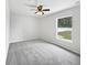 Bright bedroom with plush carpet, neutral walls, and natural light from the backyard window at 120 Marion Oaks Mnr, Ocala, FL 34473