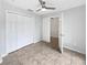 Neutral bedroom with a large closet and ceiling fan with a door leading to another room at 120 Marion Oaks Mnr, Ocala, FL 34473