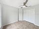 Empty bedroom featuring a ceiling fan and large closet with neutral-colored tiling at 120 Marion Oaks Mnr, Ocala, FL 34473