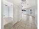 Hallway with neutral tile flooring leading to the living room at 120 Marion Oaks Mnr, Ocala, FL 34473