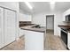 Functional kitchen features a center island, stainless steel appliances, and white cabinetry at 120 Marion Oaks Mnr, Ocala, FL 34473