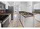 Well-equipped kitchen with stainless steel appliances, white cabinets, and a tile backsplash at 120 Marion Oaks Mnr, Ocala, FL 34473