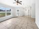 Spacious and airy living room with neutral tones, tile flooring, and large windows at 120 Marion Oaks Mnr, Ocala, FL 34473