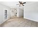 Open-concept living area showcasing tiled flooring, ceiling fan, and entryways at 120 Marion Oaks Mnr, Ocala, FL 34473