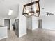 Open-concept living room featuring tile flooring, a modern light fixture, and stainless steel appliances at 120 Marion Oaks Mnr, Ocala, FL 34473