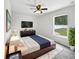 Well-lit main bedroom featuring a TV, dark wood furniture, and a white rug at 120 Marion Oaks Mnr, Ocala, FL 34473