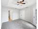 Neutral main bedroom with carpet, tray ceilings, and plenty of natural light at 120 Marion Oaks Mnr, Ocala, FL 34473