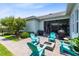 Inviting backyard space featuring a fire pit, chairs, lush landscaping, and a screened porch at 13701 Chauvin Ave, Orlando, FL 32827