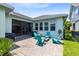 Charming backyard patio area with a fire pit, stylish turquoise chairs, and lush landscaping at 13701 Chauvin Ave, Orlando, FL 32827
