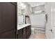 Bathroom featuring a double vanity with dark wood cabinets and a tiled shower/tub combo with neutral tones at 13701 Chauvin Ave, Orlando, FL 32827