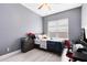 Bedroom featuring light wood flooring and a ceiling fan above the bed and a gray color scheme at 13701 Chauvin Ave, Orlando, FL 32827