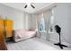 Bright bedroom featuring a daybed with tufted upholstery, modern decor, and natural light from a large window at 13701 Chauvin Ave, Orlando, FL 32827