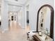 Bright hallway with tile flooring, decorative accents, and views into multiple rooms of the home at 13701 Chauvin Ave, Orlando, FL 32827