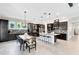 Spacious kitchen featuring dark cabinets, large island, and adjacent dining area at 13701 Chauvin Ave, Orlando, FL 32827