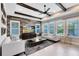 Bright living room featuring decorative beams, custom wood wall, and stylish furnishings at 13701 Chauvin Ave, Orlando, FL 32827