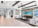 Spacious living room with decorative beams, wood wall, and lots of natural light at 13701 Chauvin Ave, Orlando, FL 32827