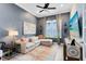 Cozy living room with a sectional sofa, large window, and TV, perfect for relaxation at 13701 Chauvin Ave, Orlando, FL 32827