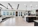 Open living space featuring beamed ceilings, and access to the kitchen and outdoor areas at 13701 Chauvin Ave, Orlando, FL 32827