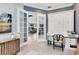 Home office with glass doors, built-in desk, and a view of the open-concept living area at 13701 Chauvin Ave, Orlando, FL 32827