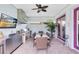 Covered outdoor dining area features an outdoor kitchen, large table, and tv above the grill at 13701 Chauvin Ave, Orlando, FL 32827
