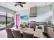 Covered outdoor kitchen and dining area with stainless steel grill and woven furniture at 13701 Chauvin Ave, Orlando, FL 32827
