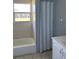 Cozy bathroom with a tub, neutral tile, and a vanity at 14330 Ellerbee St, Winter Garden, FL 34787