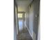 Hallway featuring neutral tile floors leading to the living area with natural light at 14330 Ellerbee St, Winter Garden, FL 34787